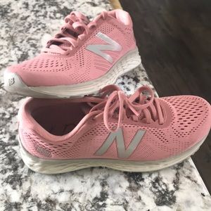 Pink and gray NewBalance lightweight tennis shoes.